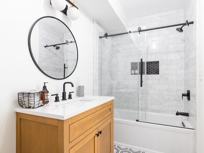 modern white bathroom with black hardware and accents