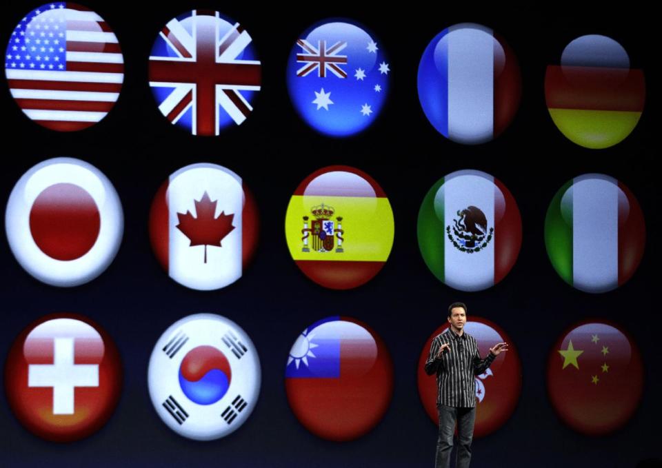 Scott Forstall, Apple's senior vice president of iOS Software, shows flags representing different languages for the new iOS 6 software, during the Apple Developers Conference in San Francisco, Monday, June 11, 2012. New iPhone and Mac software and updated Mac computers were among the highlights Monday at Apple Inc.'s annual conference for software developers. (AP Photo/Marcio Jose Sanchez)