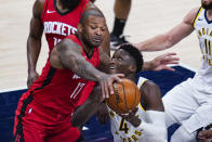 Houston Rockets forward P.J. Tucker (17) blocks the shot of Indiana Pacers guard Victor Oladipo (4) during the second quarter of an NBA basketball game in Indianapolis, Wednesday, Jan. 6, 2021. (AP Photo/Michael Conroy)