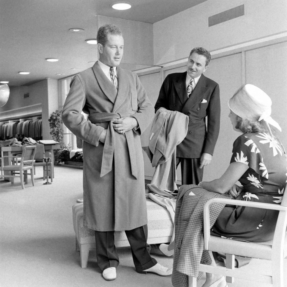 A man trying on a bathrobe at Neiman Marcus in Dallas, May 1945.