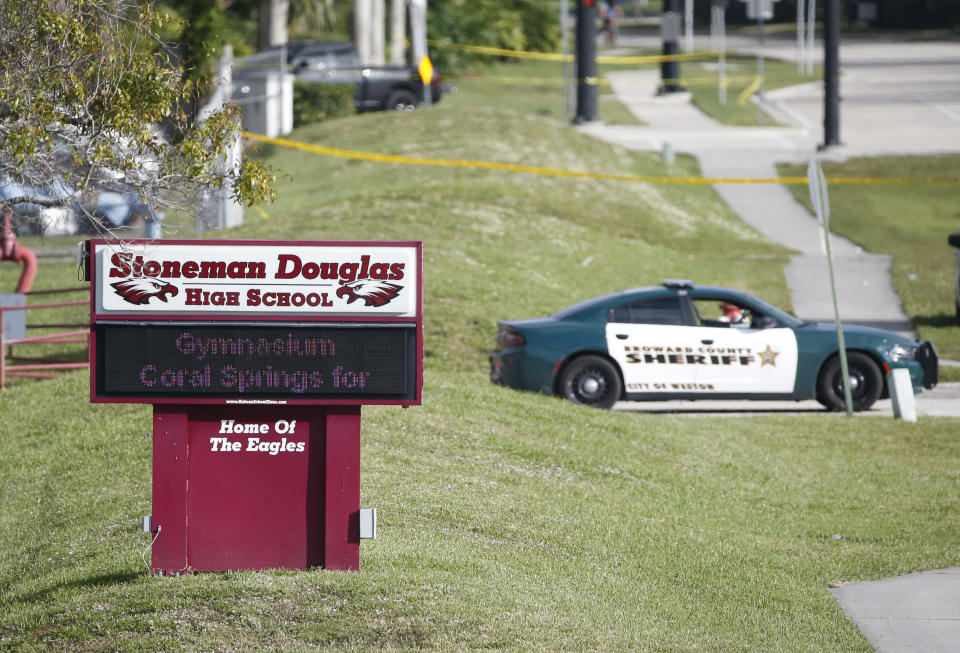 Law enforcement officers block off the entrance to Marjory Stoneman Douglas High School in Parkland, Florida, on Feb. 15, 2018, after a mass shooting left 17 people dead. (Photo: ASSOCIATED PRESS)