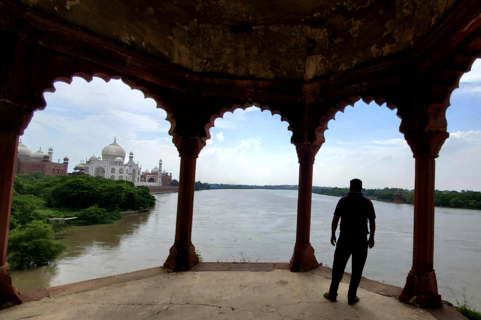 A man looks at a swollen Yamuna river flowing up to the periphery of the Taj Mahal monument in Agra, India, Wednesday, July 19, 2023. India regularly witnesses severe floods during the monsoon season, which runs between June and September and brings most of South Asia’s annual rainfall. (AP Photo/Aryan Kaushik)