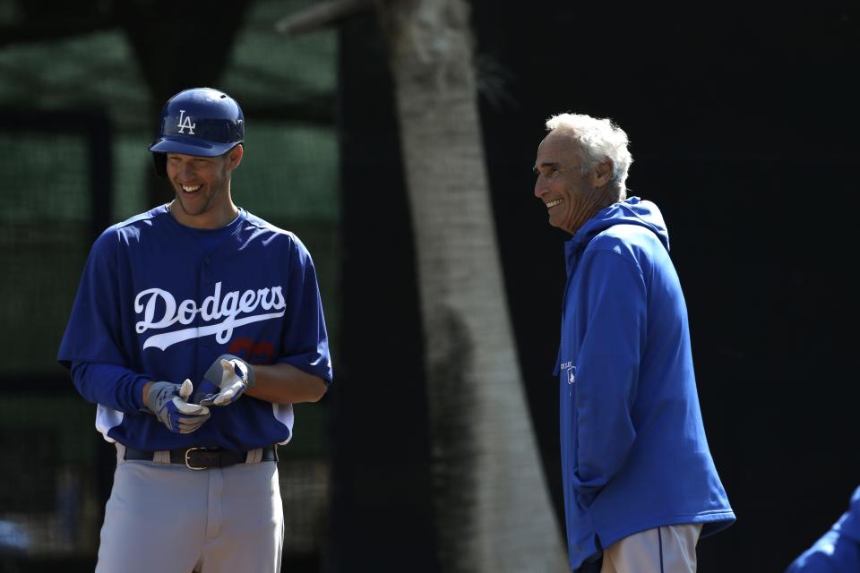 Los Angeles Dodgers starting pitcher Clayton Kershaw, left, laughs with Sandy Koufax during spring training baseball in Phoenix, Thursday, Feb. 21, 2013.  (AP Photo/Paul Sancya)