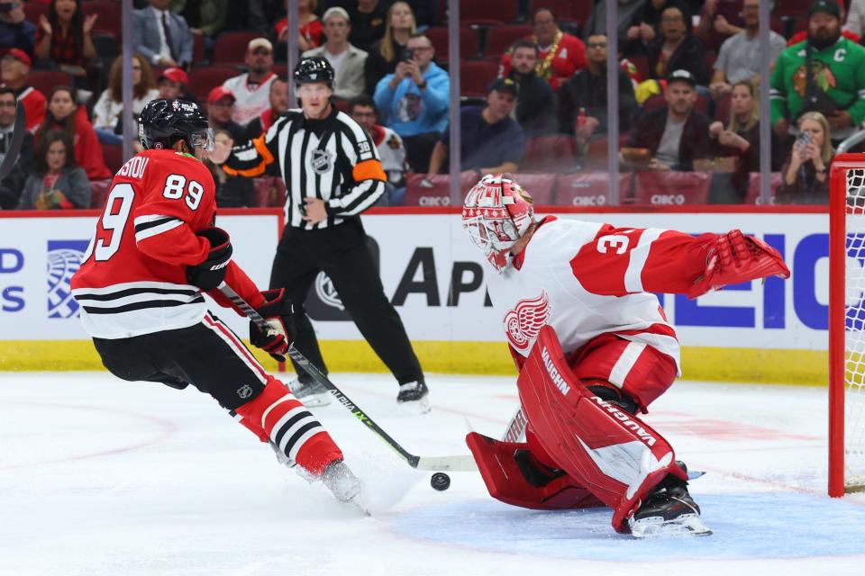 Andreas Athanasiou of the Chicago Blackhawks takes a shot on goal against Alex Nedeljkovic of the Detroit Red Wings during the second period at United Center in Chicago on Friday, Oct. 21, 2022.