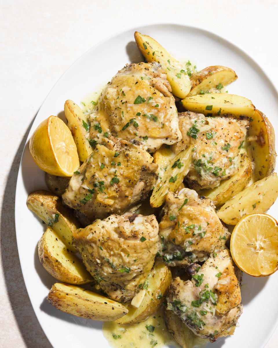 This image released by Milk Street shows a recipe for chicken and potato traybake with garlic, lemon and parsley. (Milk Street via AP)