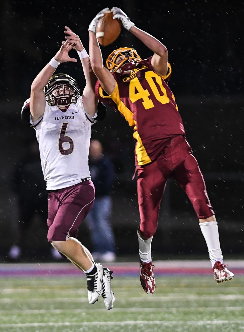 Scecina Memorial's Mason Beriault (40) catches a pass over Lutheran's Campbell Richardson (6) during the second half of the game on Friday, September 23, 2022, hosted at Roncalli High School Indianapolis. Lutheran defeated the Scecina Memorial 28-19.