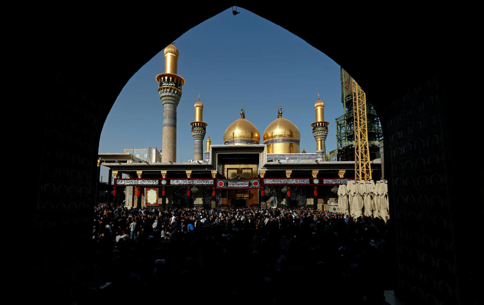 Shiite worshippers gather at the golden-domed shrine of Imam Moussa al-Kadhim, who died at the end of the 8th century, during the annual commemoration of the saint's death, in Baghdad, Iraq, Wednesday, March 10, 2021. (AP Photo/Hadi Mizban)