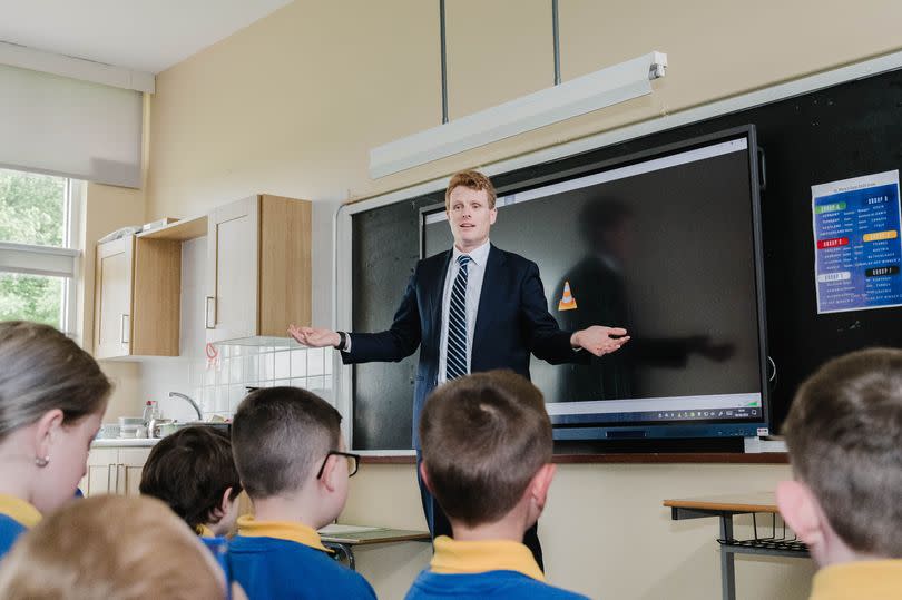 Joe standing at the front of the classroom