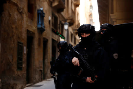 Armed police officers of the Malta Police Special Intervention Unit provide security as three men, accused of the assassination of anti-corruption journalist Daphne Caruana Galizia, arrive for their lawyers’ submissions for bail at the Courts of Justice in Valletta, Malta April 17, 2018. REUTERS/Darrin Zammit Lupi