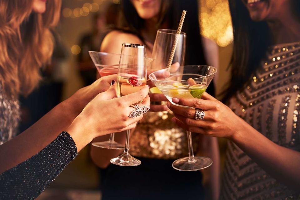 <p>monkeybusinessimages/Getty</p> People toasting drinks