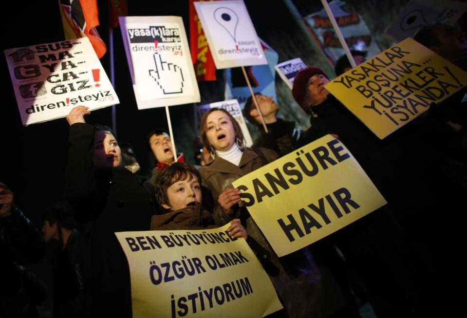 Protesters shout slogans, hold banners and wave flags as they demonstrate against new controls on the Internet approved by Turkish parliament this week in Ankara