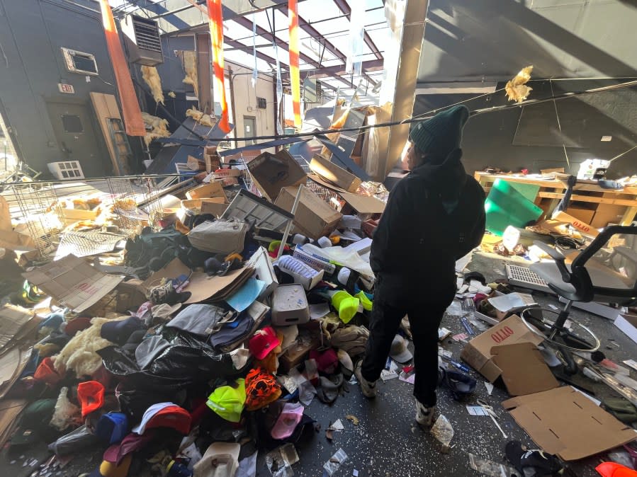 N.B. Goods owner Camille Alston looks at the rubble in her store’s warehouse in Madison. (Photo: WKRN)