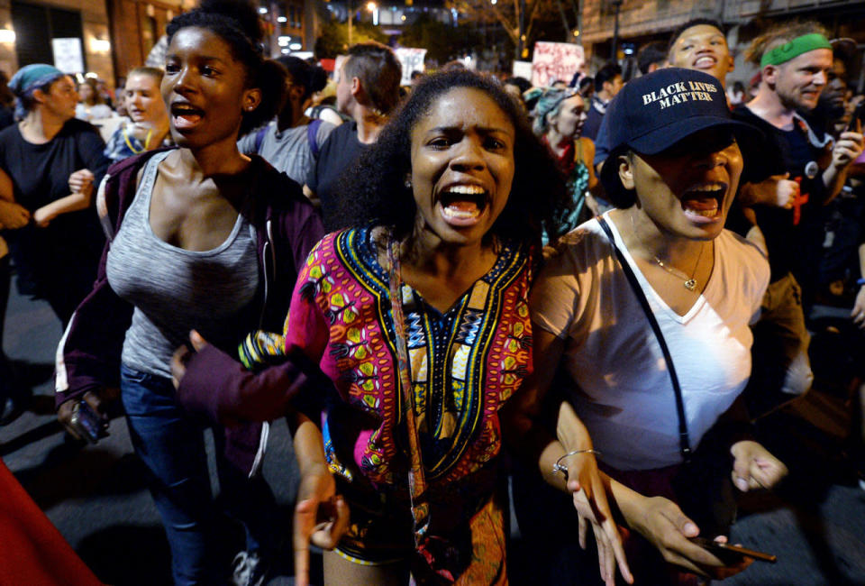 <p>Protesters chant “Black Lives Matter” as they march throughout the city of Charlotte, N.C., on Friday, Sept. 23, 2016, as demonstrations continue following the shooting death of Keith Scott by police earlier in the week. (Jeff Siner/Charlotte Observer/TNS via Getty Images)</p>