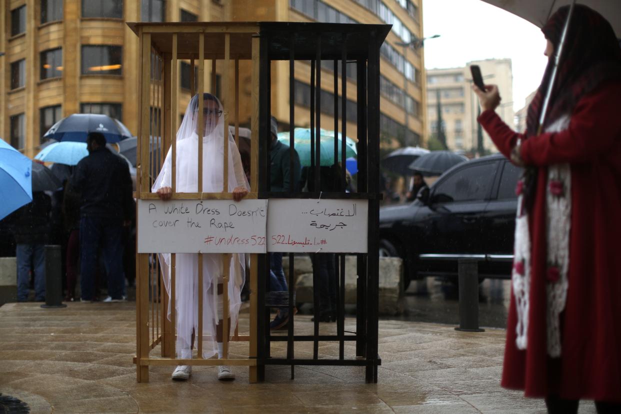 An activist from Abaad, a women's rights group in Lebanon, protests a law that shields rapists from prosecution on the condition that they marry their victim. (Photo: PATRICK BAZ via Getty Images)