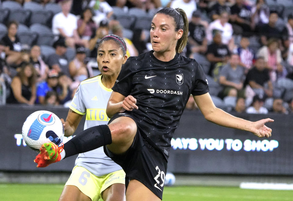 Angel City FC's Clarisse Le Bihan, right, kicks the ball next to Tigres UANL's Nancy Anthony during the first half of a club friendly soccer match in Los Angeles on Wednesday, Aug. 10, 2022. (Keith Birmingham/The Orange County Register via AP)