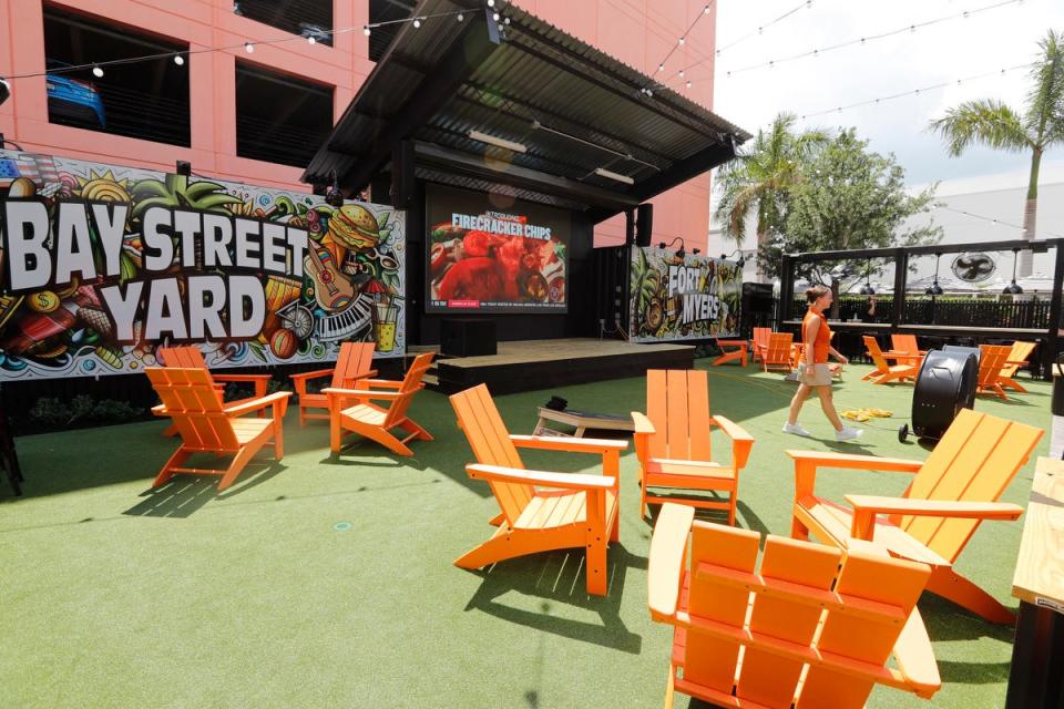 Staffers work on last-minute preparations Wednesday afternoon, May 22, 2024, at the Downtown Fort Myers outdoor venue Bay Street Yard. The establishment will include bars, concert stage, food truck spaces as well as table games among other amenities.