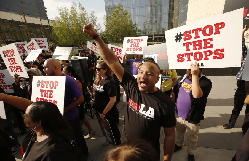 LOS ANGELES, CA - OCTOBER 09, 2019 Kirk Samuels with Community Coalition chants with a group of nearly 100 people in a new coalition of 15 social justice organizations across Los Angeles called PUSH LA "Reimagine Protect and Serve" massed for a press conference in front of LAPD Headquarters Wednesday morning with demands to Mayor Eric Garrett and LAPD Chief Michel Moore on police reform. The press conference was called after data featured in the LA Times revealed that LAPD is searching Black and Latinx drivers at rates of 4 to 1 and 3 to 1, respectively, compared to white drivers, but that they're finding less contraband. The group notes of there 350,000 stops analyzed over a 10 moth period, nearly three quarters of those stripped were Black and Latinx drivers and many of these searches happened after stops for minor equipment violations. The group claims these disparities are clear evidence of racial profiling that is happening across all divisions of the LAPD. (Al Seib / Los Angeles Times)