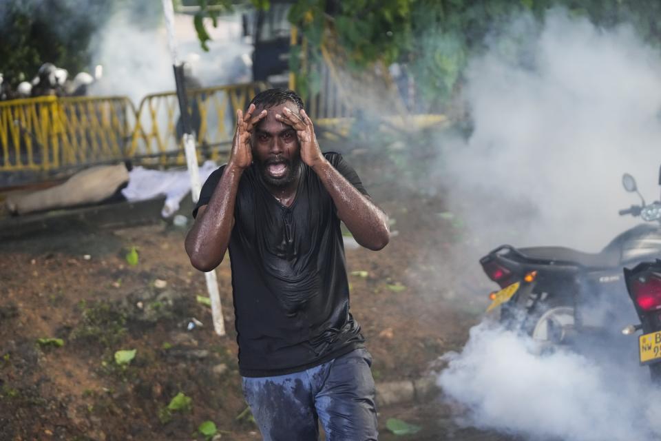 An injured protester grieves in pain as police fire tear gas to disperse protesting members of the Inter University Students Federation during an anti government protest in Colombo, Sri Lanka, May 19, 2022. The image was part of a series of images by Associated Press photographers that was a finalist for the 2023 Pulitzer Prize for Breaking News Photography. (AP Photo/Eranga Jayawardena)