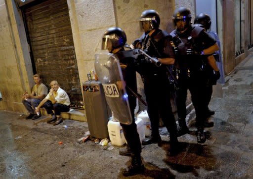 Riot police stand guard in Madrid after a protest against the Spanish government's latest austerity measures, on July 19, 2012. Spanish police fired rubber bullets and charged protestors in central Madrid early Friday at the end of a huge demonstration against economic crisis measures