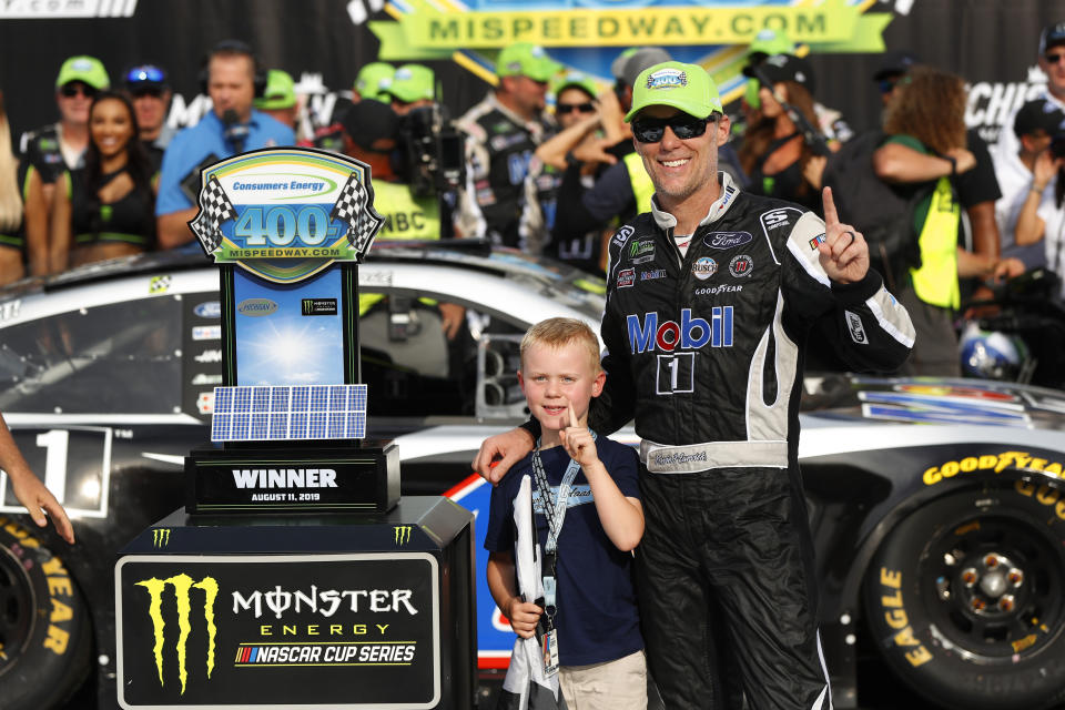 Kevin Harvick celebrates with his son, Keelan, after winning a NASCAR Cup Series auto race at Michigan International Speedway in Brooklyn, Mich., Sunday, Aug. 11, 2019. (AP Photo/Paul Sancya)