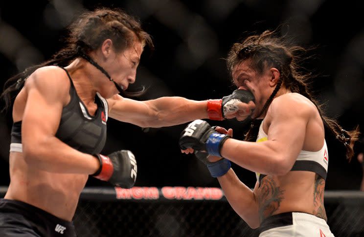 Joanna Jedrzejczyk (L) punches Claudia Gadelha during their title fight on Friday. (Getty)