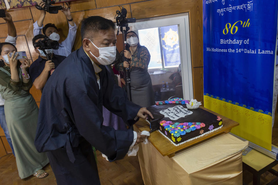 President of the Central Tibetan Administration Penpa Tsering, cuts a cake during a ceremony to mark the 86th birthday of their spiritual leader the Dalai Lama in Dharmsala, India, Tuesday, July 6, 2021. This year, due to the coronavirus pandemic, the celebrations were muted and behind closed doors. (AP Photo/Ashwini Bhatia)