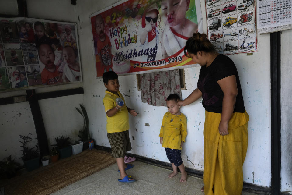 Diana Khumanthem, 30, plays with her three-year-old nephew Hridhaan, who she has decided to raise as her own after his mother Ranjita died of COVID-19, at home in Imphal, in the northeastern Indian state of Manipur, Monday, June 28, 2021. Diana lost both her mother and sister to the virus in May. Treatment costs wiped out the family's savings, and the private hospital where she died wouldn’t release her sister’s body for last rites until a bill of about $5,000 was paid. Data on global personal medical costs from the pandemic are hard to come by, but in India and many other countries treatment for COVID is a huge added burden at a time when hundreds of millions of jobs have vanished. (AP Photo/Yirmiyan Arthur)