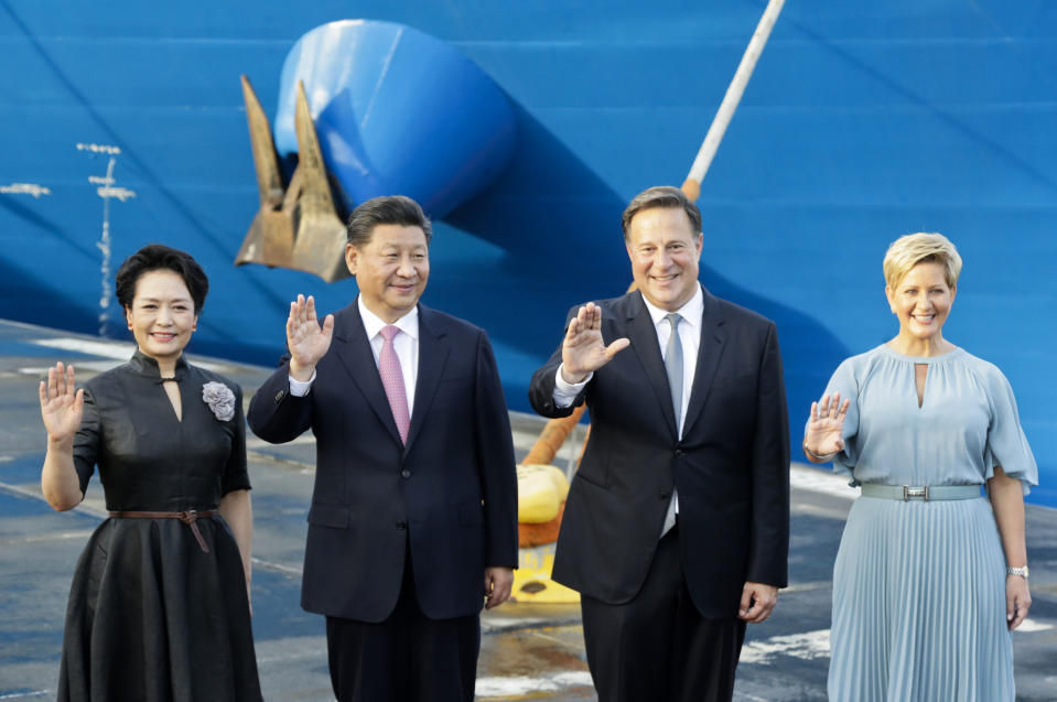 FILE - In this Dec. 3, 2018, file photo, from left, China's first lady Peng Liyuan, President Xi Jinping, Panama's President Juan Carlos Varela and first lady Lorena Castillo, wave as they pose for an official photo at the Panama Canal's Cocoli locks, in Panama City. China’s expansion in Latin America of its Belt and Road initiative to build ports and other trade-related facilities is stirring anxiety in Washington. As American officials express alarm at Beijing’s ambitions in a U.S.-dominated region, China has launched a charm offensive, wooing Panamanian politicians, professionals, and journalists. (AP Photo/Arnulfo Franco, File)