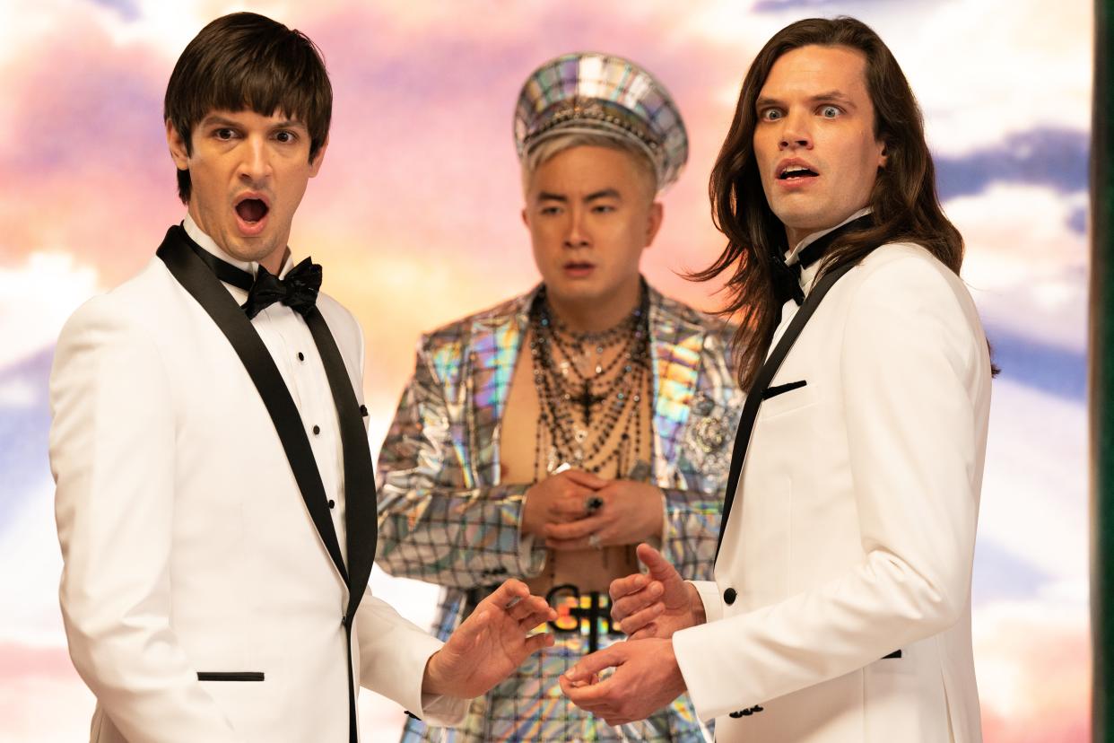 God (Bowen Yang, center) shares screen time with a pair of identical twins (Josh Sharp and Aaron Jackson) in "Dicks: The Musical."