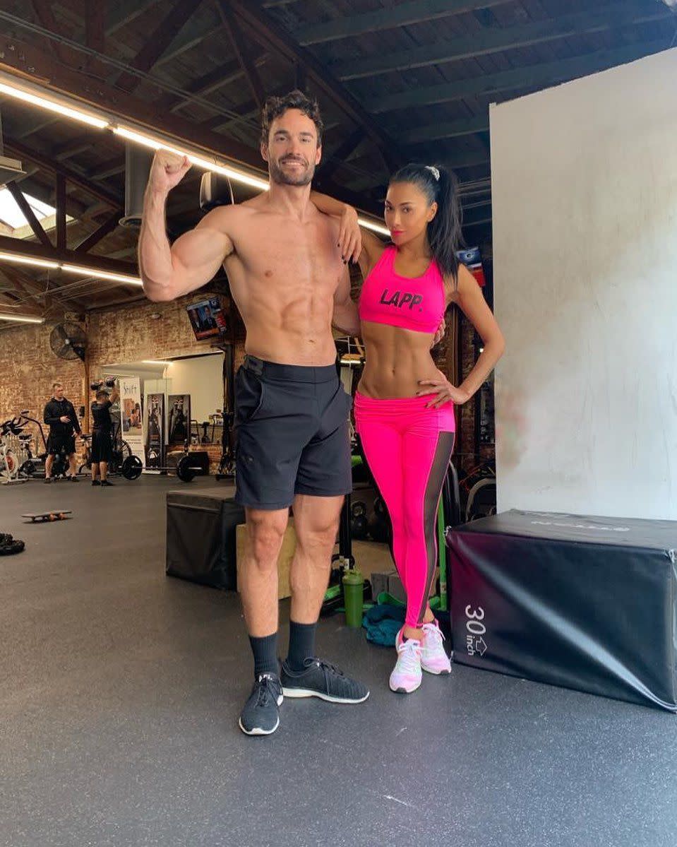 Nicole Scherzinger and Thom Evans pose in the gym