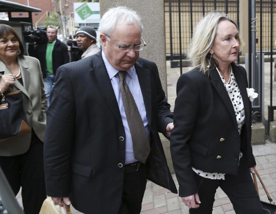 June Steenkamp, mother of Reeva Steenkamp, right, accompanied by an unidentified man, arrives at the high court in Pretoria, South Africa, Tuesday, May 6, 2014. Using witness accounts of a panicked nighttime phone call from Oscar Pistorius begging for help and his desperate pleas for Reeva Steenkamp to stay alive, the defense at his murder trial tried to reinforce its case Monday that the double-amputee Olympian fatally shot his girlfriend in a tragic error of judgment. (AP Photo/Themba Hadebe)