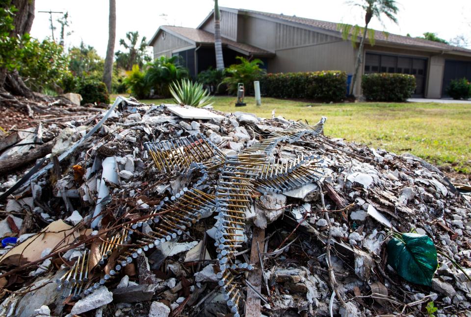 A pile of construction debris is seen outside one of the homes in Island Park Village on Friday, Jan. 5, 2024. The condos in the neighborhood were damaged by flooding from Hurricane Ian, and many are still being fixed after problems with contractors delayed repairs.