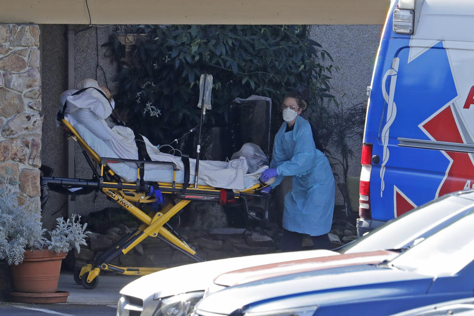 A patient is loaded into an ambulance at the Life Care Center in Kirkland, Wash. Monday, March 9, 2020, near Seattle. The nursing home is at the center of the outbreak of the COVID-19 coronavirus in Washington state. (AP Photo/Ted S. Warren)