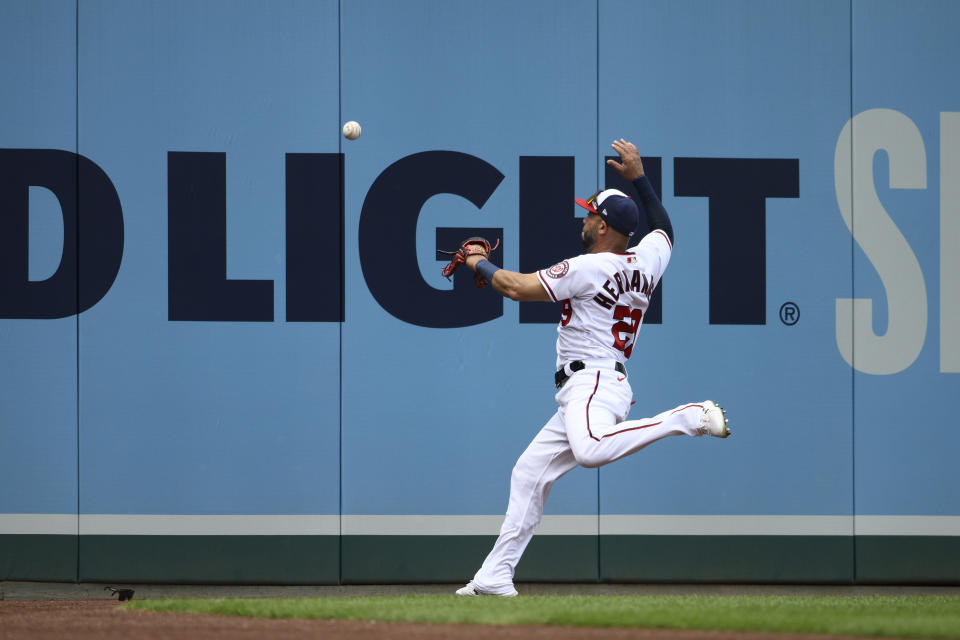 Washington Nationals left fielder Yadiel Hernandez chases a ball hit by Atlanta Braves' Adam Duvall for a double during the fourth inning of a baseball game, Sunday, July 17, 2022, in Washington. (AP Photo/Nick Wass)