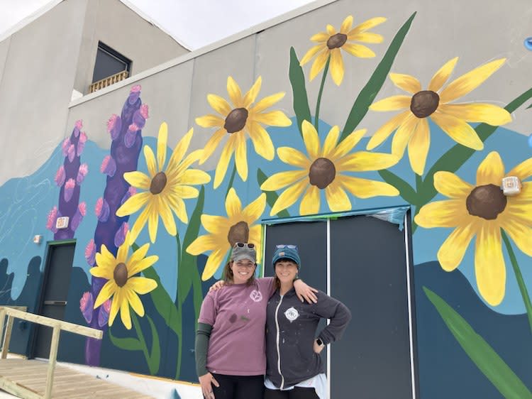 Dawn, left, with fellow QC muralist Heidi Sallows, who also worked on the YWCA project.