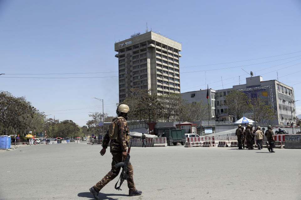 Afghan Security personnel arrive outside the Telecommunication Ministry during a gunfight with insurgents in Kabul, Afghanistan, Saturday, April 20, 2019. Afghan officials say an explosion has rocked the telecommunications ministry in the capital city of Kabul. Nasart Rahimi, a spokesman for the interior ministry, said Saturday the blast occurred during a shootout with security forces. (AP Photo/Rahmat Gul)