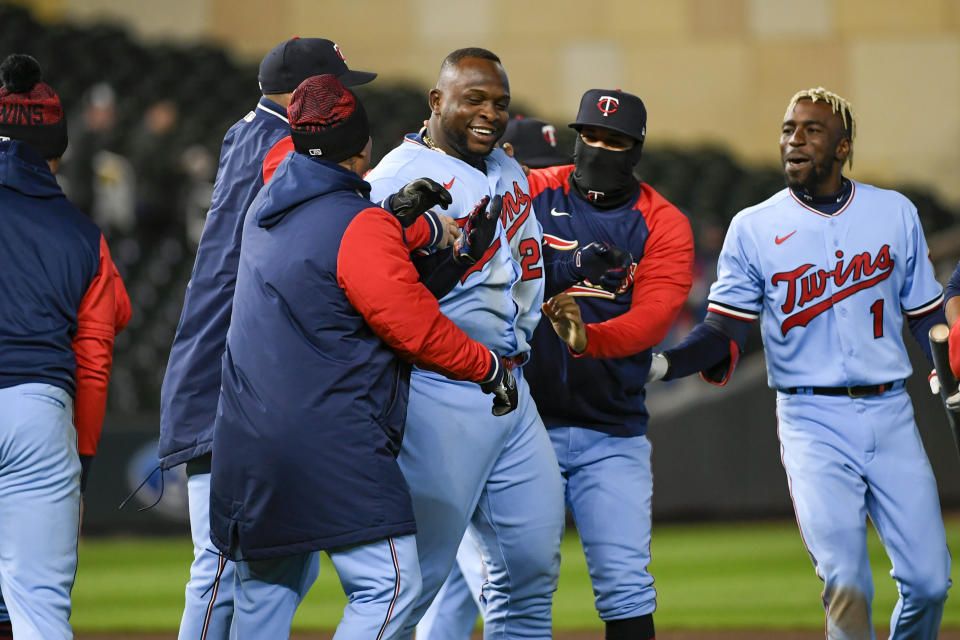Minnesota Twins' Miguel Sano, third from right, celebrates with teammates after Sano hit a single during the ninth inning of a baseball game against the Detroit Tigers during a baseball game Tuesday, April 26, 2022, in Minneapolis. There was an error on the play, and the Twins scored two runs, winning 5-4. (AP Photo/Craig Lassig)
