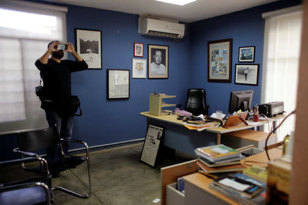 A local photographer makes a video of journalist Carlos Fernando Chamorro's office, which was raided Thursday night by the national police in Managua, Nicaragua December 14, 2018. REUTERS/Oswaldo Rivas