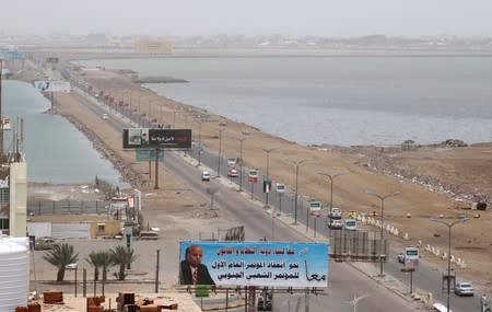 Cars drive on a road linking two neighborhoods of Aden, Yemen