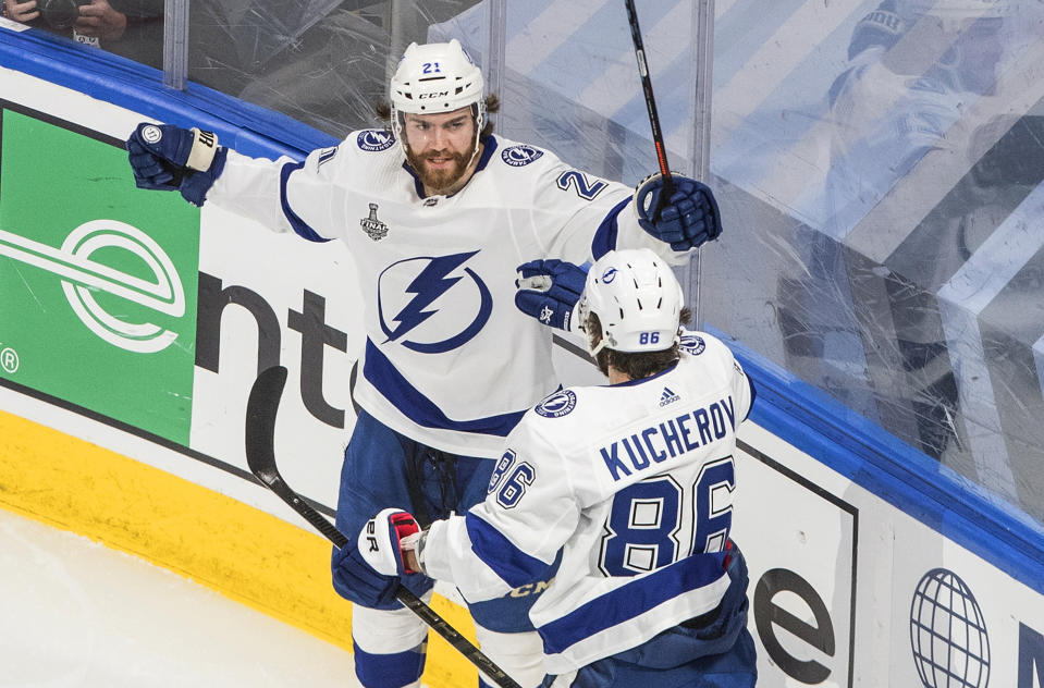 Tampa Bay Lightning center Brayden Point (21) celebrates his goal against the Dallas Stars with Nikita Kucherov (86) during the second period of Game 4 of the NHL hockey Stanley Cup Final, Friday, Sept. 25, 2020, in Edmonton, Alberta. (Jason Franson/The Canadian Press via AP)