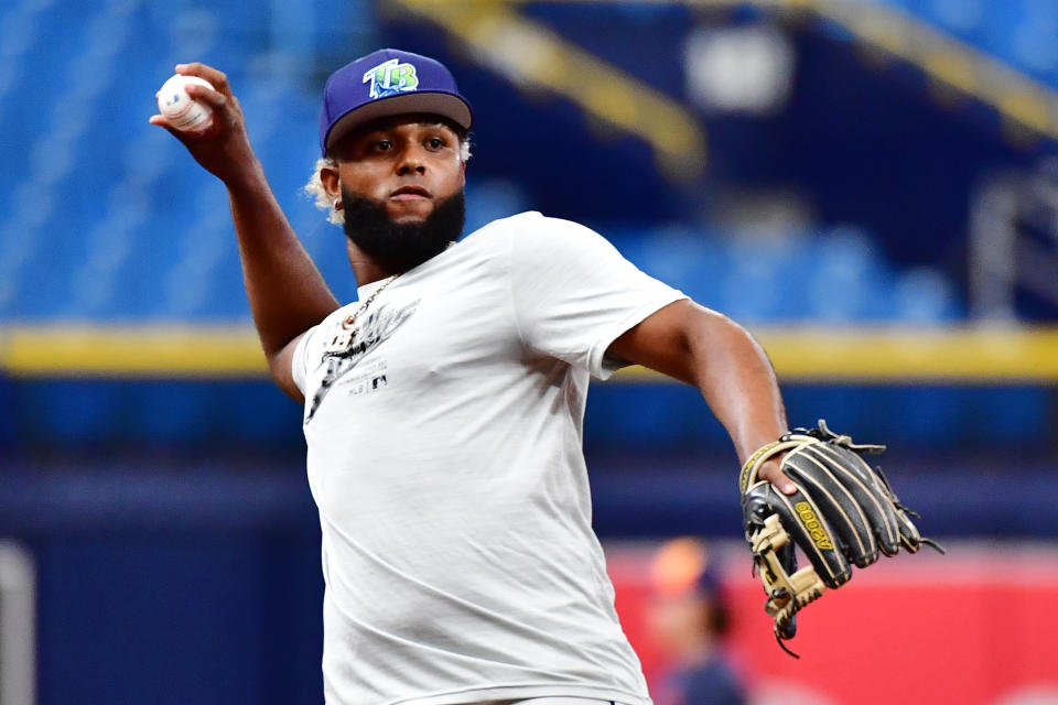 ST PETERSBURG, FLORIDA - AUGUST 13: Junior Caminero #13 of the Tampa Bay Rays fields a ball during batting practice prior to a game against the Houston Astros at Tropicana Field on August 13, 2024 in St Petersburg, Florida. (Photo by Julio Aguilar/Getty Images)