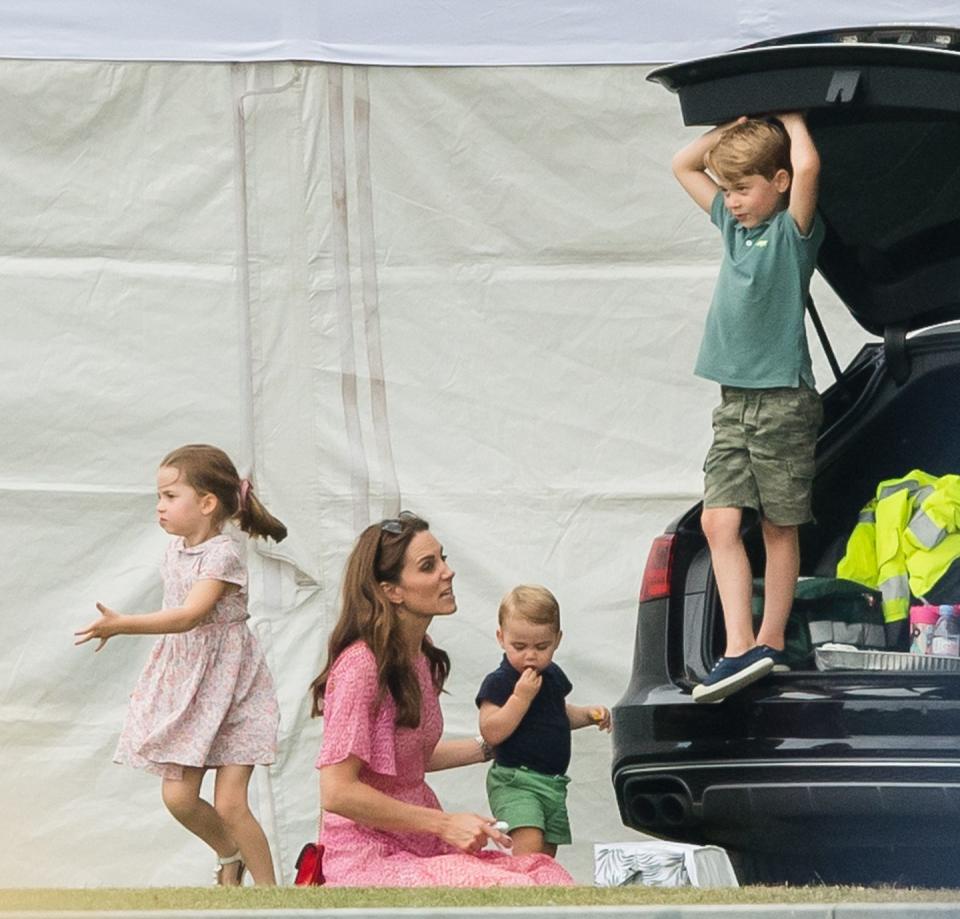 <p>The dynamic changes when kids outnumber adults. Prince George plays in the car trunk at the King Power Royal Charity Polo Day at Billingbear Polo Club. </p>