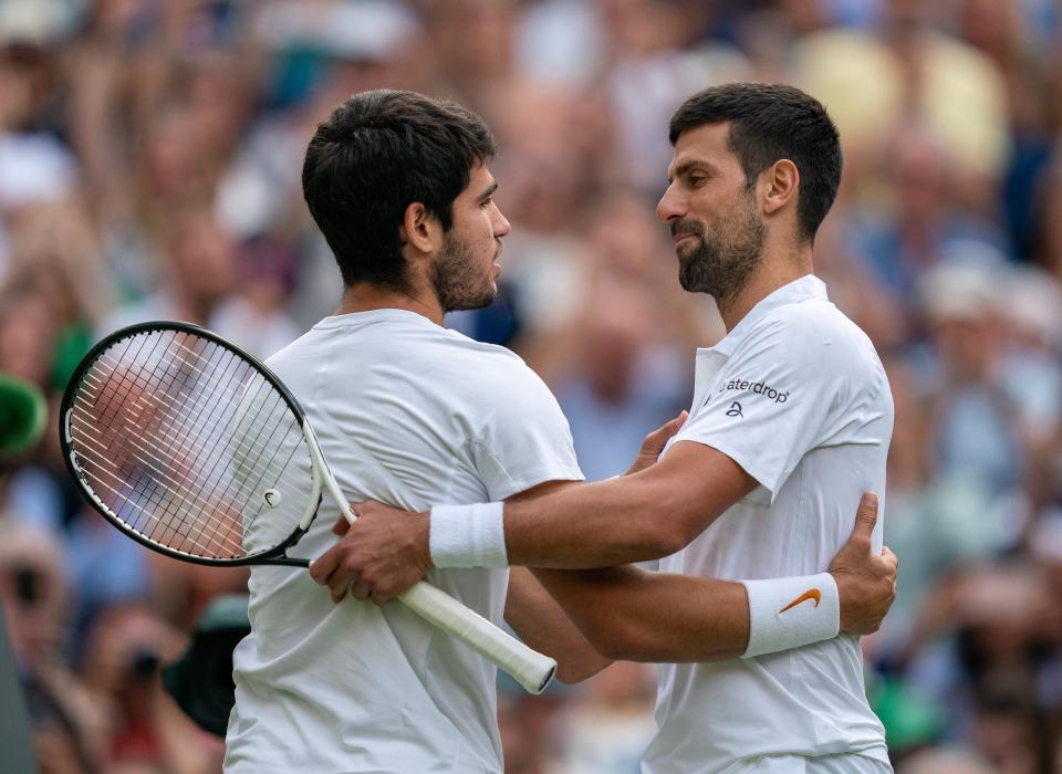 Carlos Alcaraz (left) and Novak Djokovic at the net after the 2023 men’s final at Wimbledon.