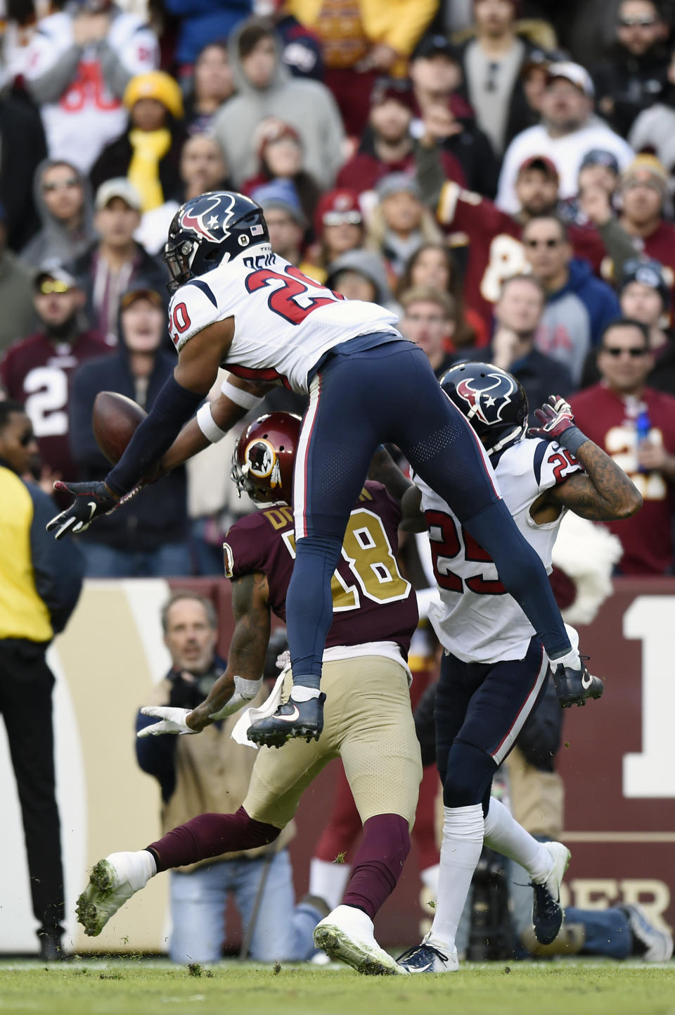 <p>Justin Reid #20 and Kareem Jackson #25 of the Houston Texans break up a pass intended for Josh Doctson #18 of the Washington Redskins in the fourth quarter at FedExField on November 18, 2018 in Landover, Maryland. (Photo by Patrick McDermott/Getty Images) </p>