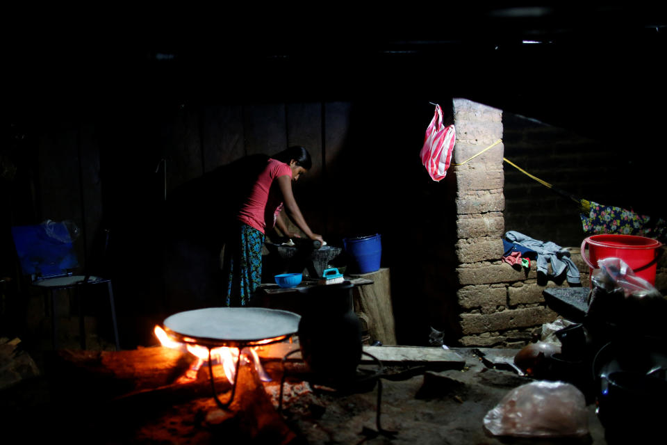 A woman makes corn tortillas at her home in Juquila Yucucani