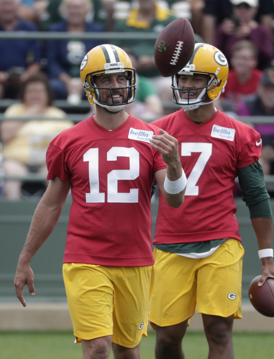 FILE - In this July 26, 2018, file photo, Green Bay Packers' Aaron Rodgers smiles during NFL football training camp, in Green Bay, Wis. Tom Brady tops The Associated Press rankings of NFL quarterbacks at age 41. It’s the second straight season the New England Patriots’ star has edged Green Bay quarterback Aaron Rodgers, although Rodgers closed the gap this year. Brady is the league’s reigning MVP and coming off a record eighth trip to the Super Bowl while Rodgers is coming back from a shoulder injury that knocked him out for half of the 2017 season. (AP Photo/Morry Gash, File)