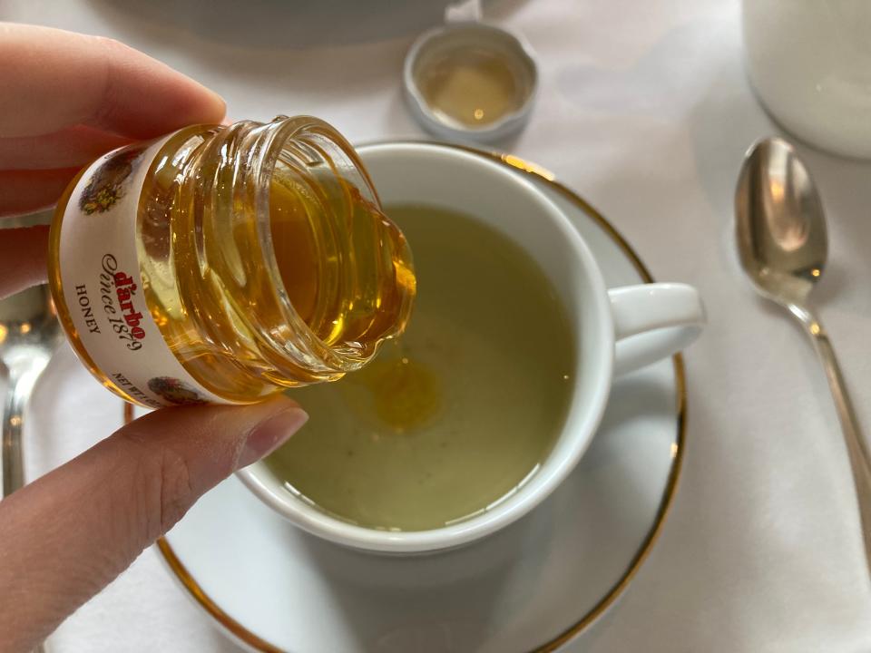 Pouring honey into a teacup at BG restaurant at Bergdorf Goodman.