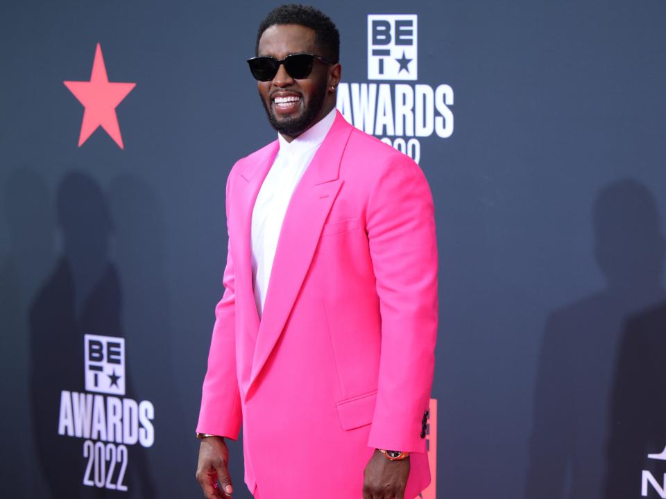 Sean Combs in a pink suit on a red carpet