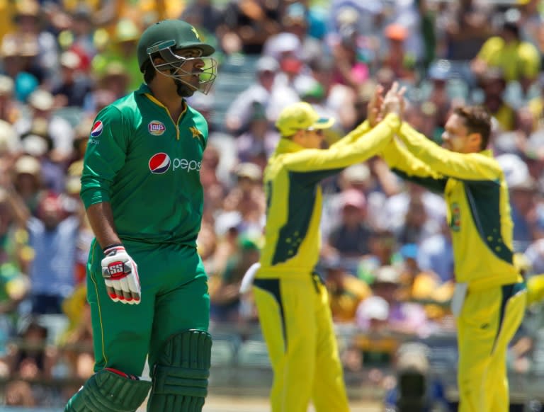 Pakistan's Sharjeel Khan (L) walks off the field after being bowled during their third ODI match against Australia, at the WACA in Perth, on January 19, 2017