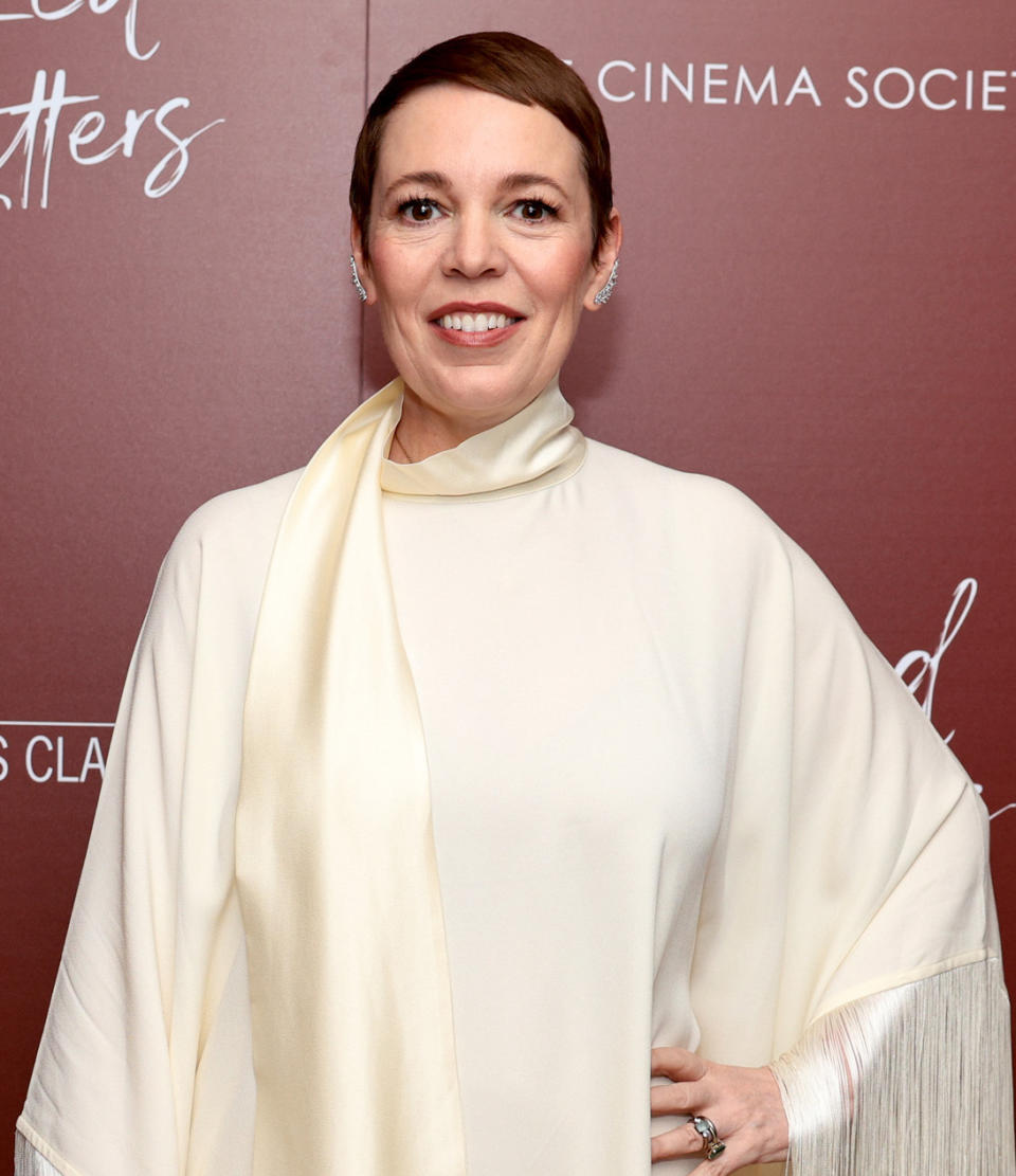 Olivia Colman in a cream draped ensemble at an event